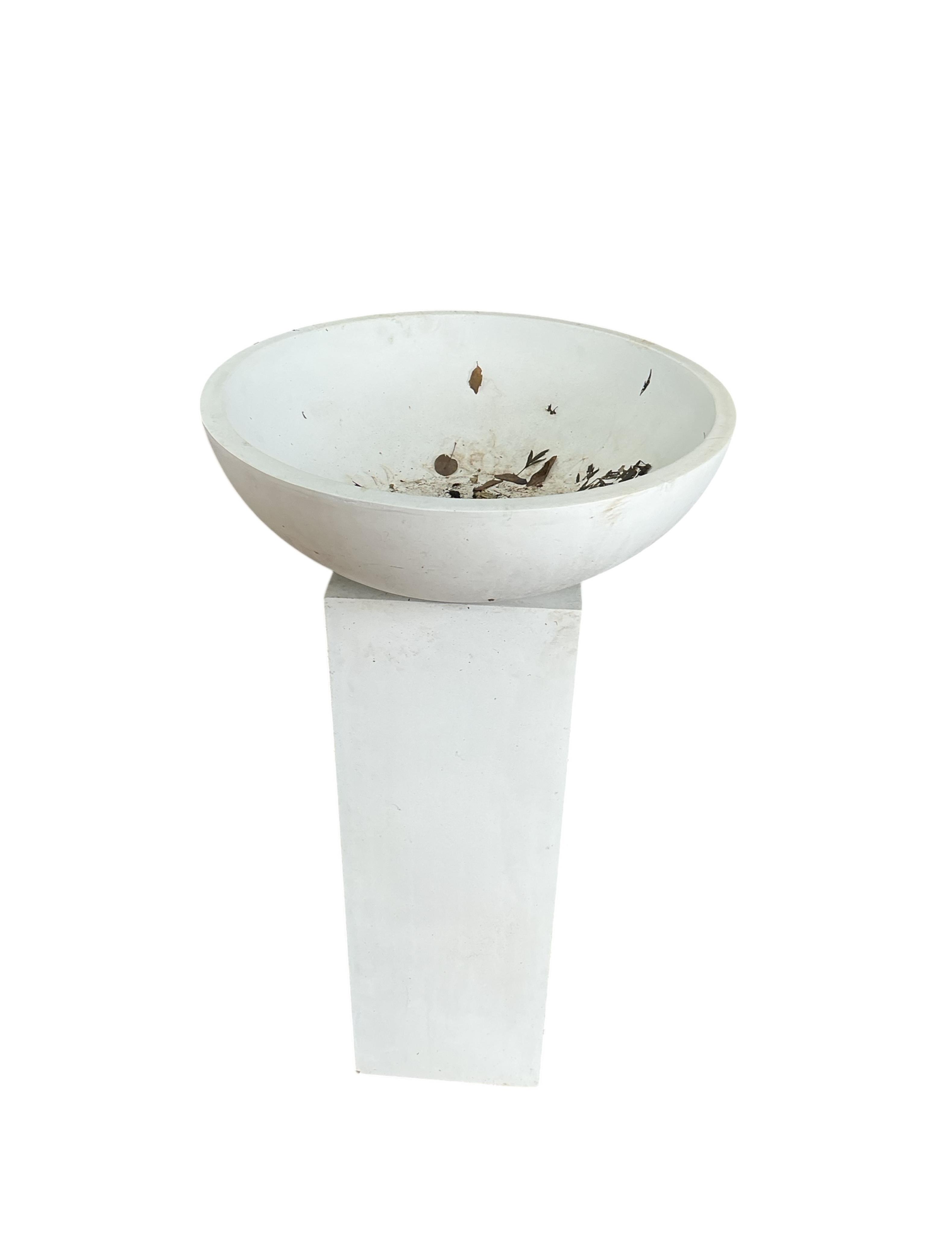 A pair of contemporary circular composition planters on square pedestal bases, diameter 60cm, height 112cm